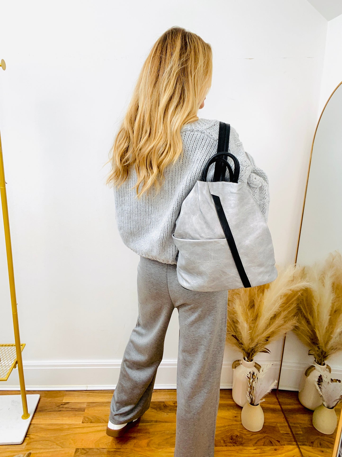 Grey rucksack and grey jumper and joggers