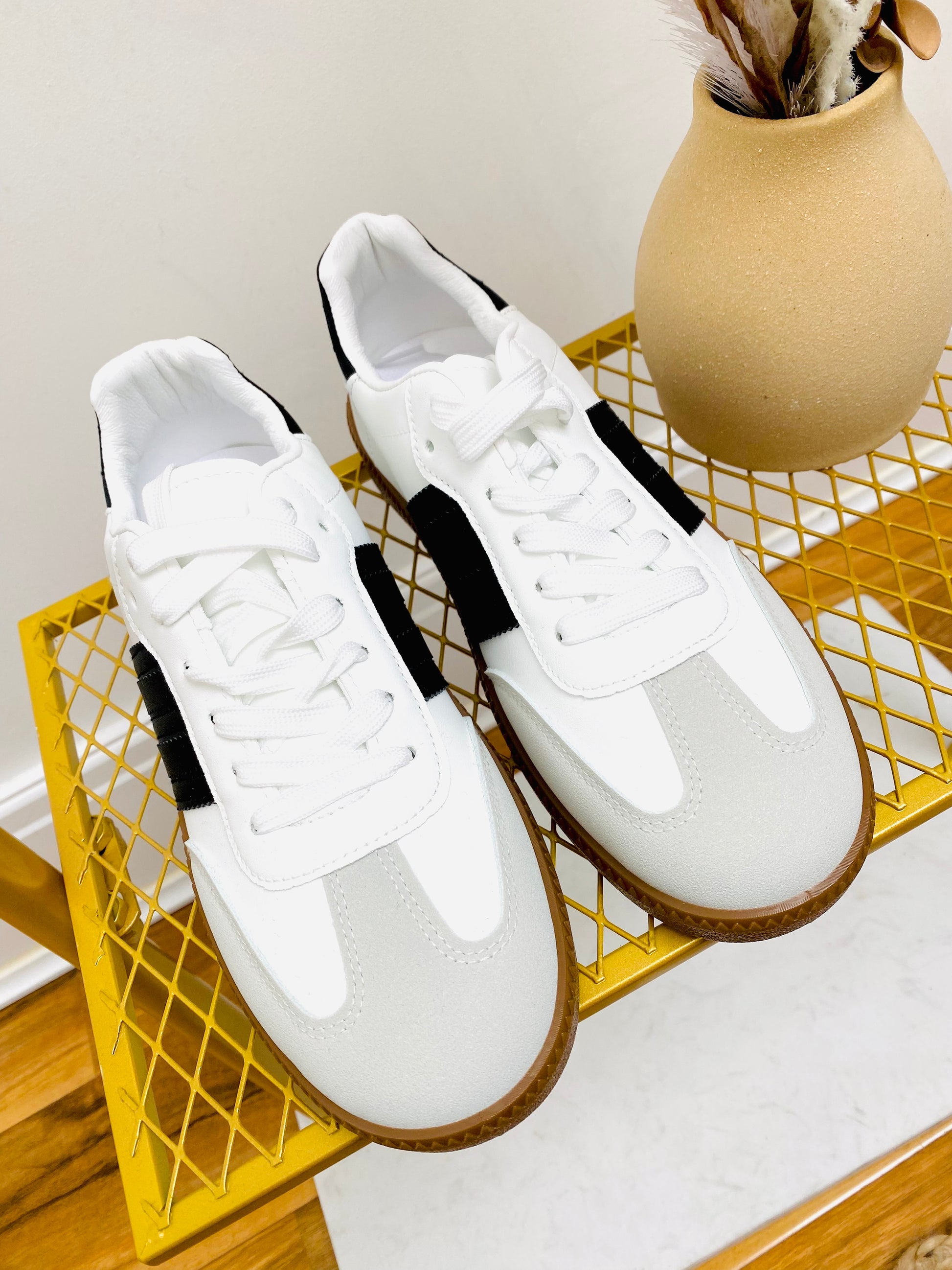 White faux leather sneaker  trainer with black stripe and grey faux suede toe with gum sole.