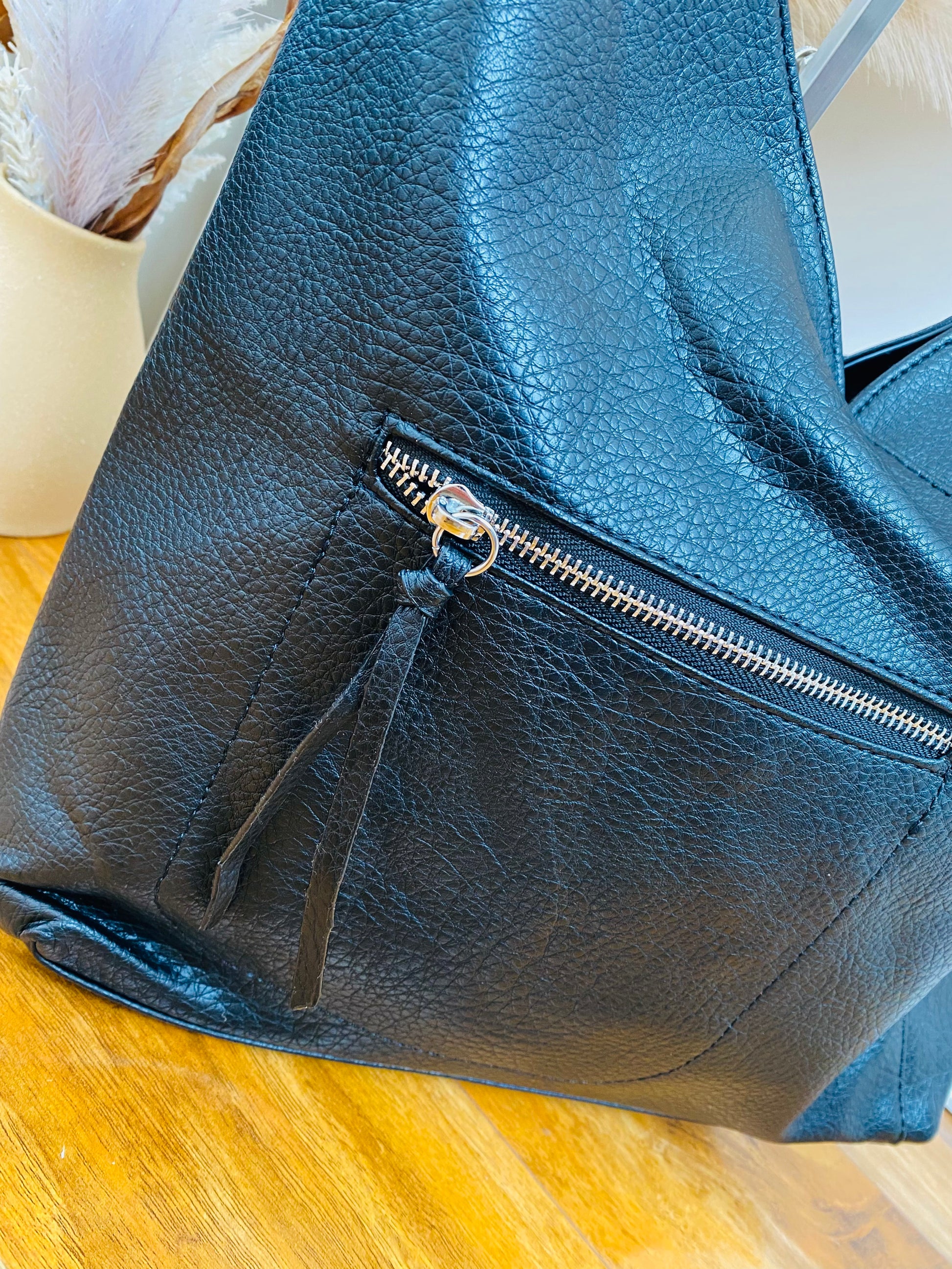Faux leather touch shoulder bag with silver zip and front pocket