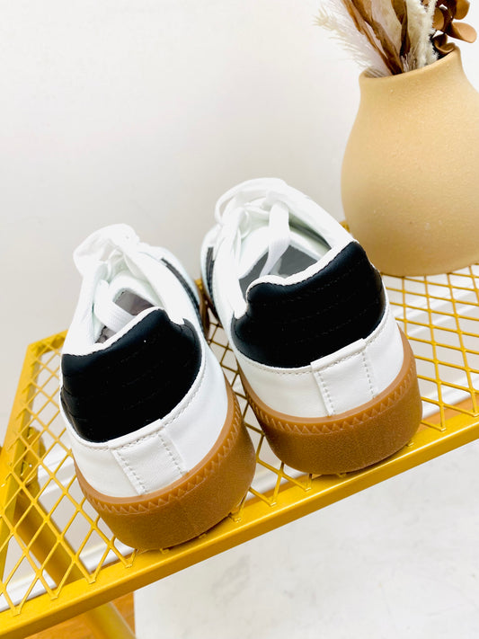 White faux leather sneaker  trainer with black stripe and grey faux suede toe with gum sole.
