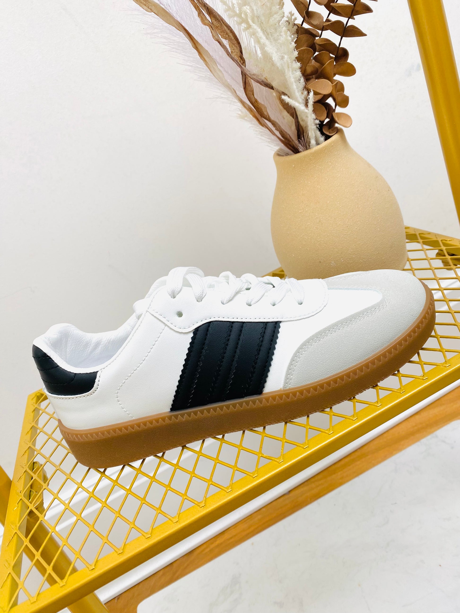 White faux leather sneaker  trainer with black stripe and grey faux suede toe with gum sole.