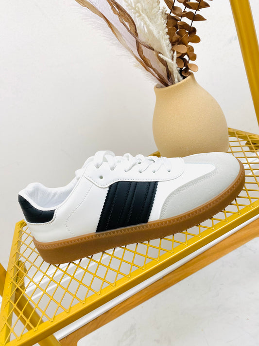 White faux leather sneaker  trainer with black stripe and grey faux suede toe with gum sole.